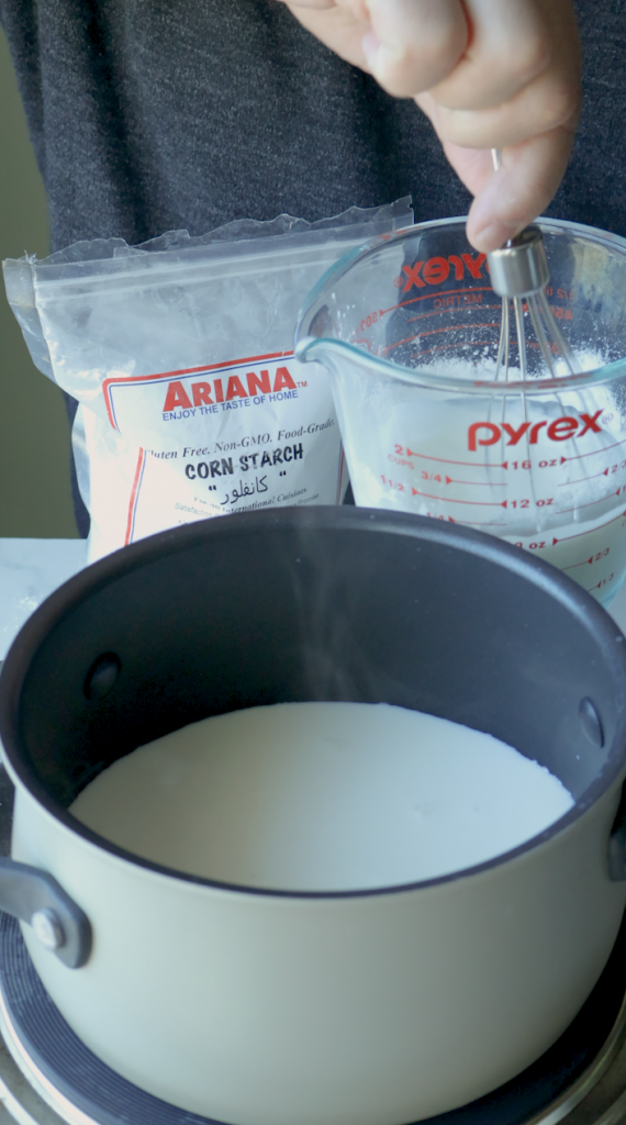 1. Start by measuring 2 cups whole milk. Pour one and half cups into a sauce pan.
2. Then the last half cup, mix with 1/3 cup corn starch.
3. Then add that into the sauce pan with the rest of the milk.